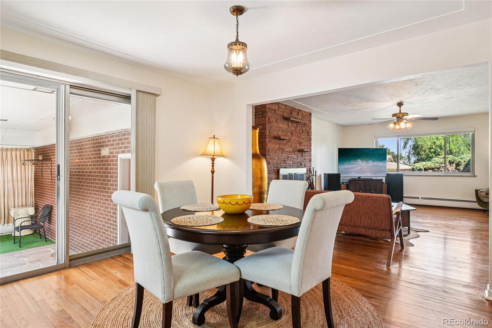 6920 West 47th Place Wheat Ridge, CO 80033 - Photo 8 of 43 a view of a dining room with furniture window and wooden floor