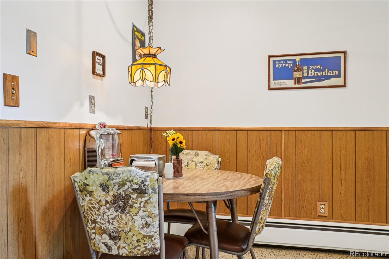 6920 West 47th Place Wheat Ridge, CO 80033 - Photo 10 of 43 a view of a dining room with furniture and wooden floor