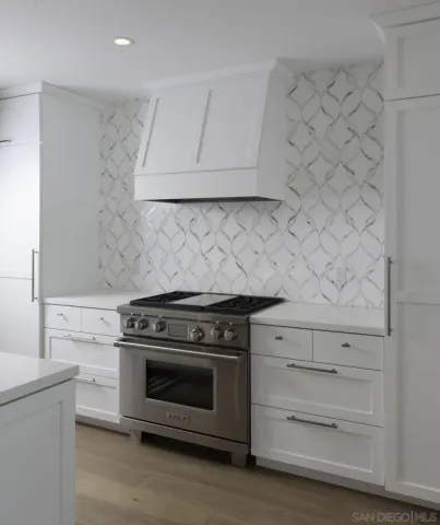 a stove top oven sitting inside of a kitchen