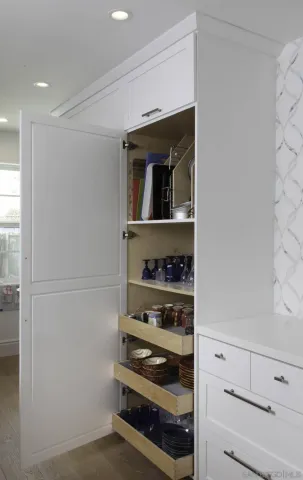 a kitchen with white cabinets and a stove