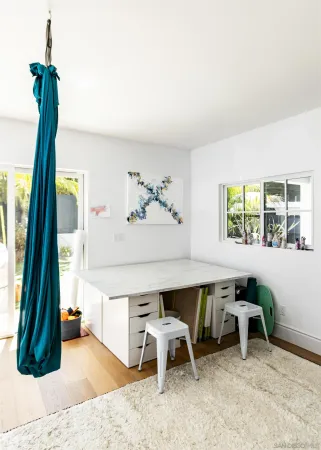a dining room with furniture and a window