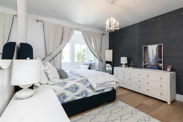 a bedroom with a bed and a chandelier