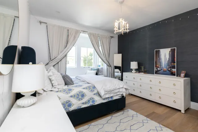 a bedroom with a bed and a chandelier