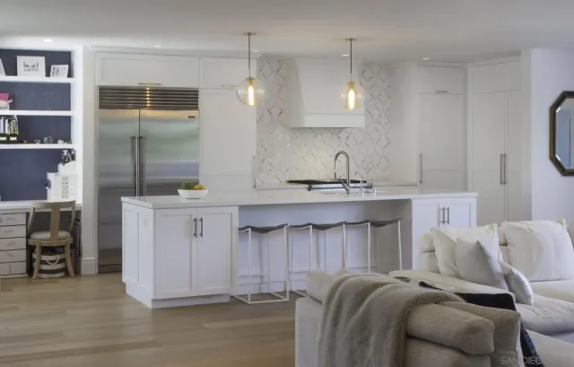 a kitchen with a sink refrigerator and cabinets