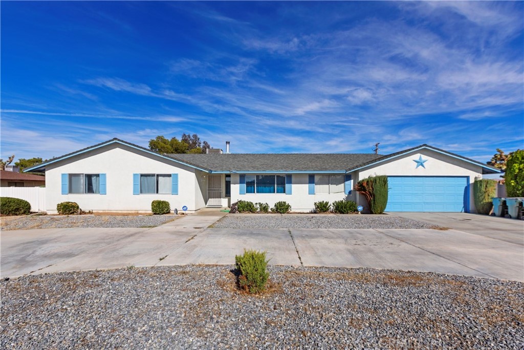 20340 Sitting Bull Road Apple Valley, CA 92308 - Photo 1 of 1 a front view of a house with a yard