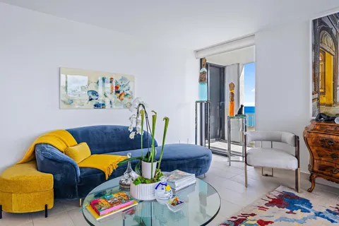 a bedroom with furniture and painting on the wall