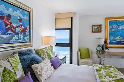 a bathroom with a tub a sink a mirror and a shower