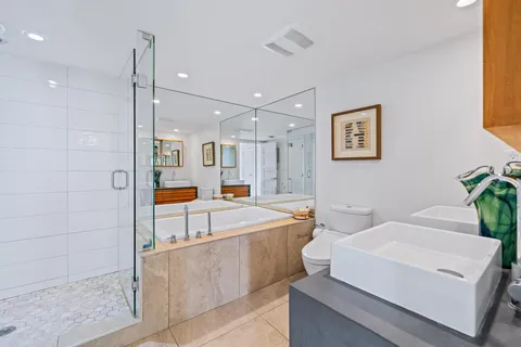 a bathroom with a granite countertop sink mirror and toilet