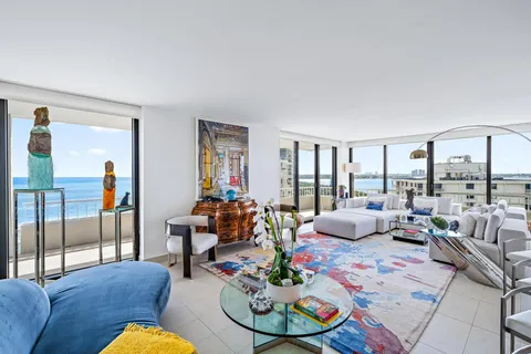 an aerial view of a tennis ground and a cars park side of the road
