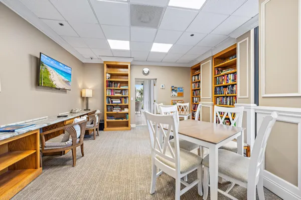 a view of a balcony with floor to ceiling windows and outdoor kitchen