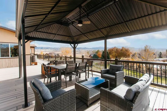a view of a balcony with furniture and wooden floor