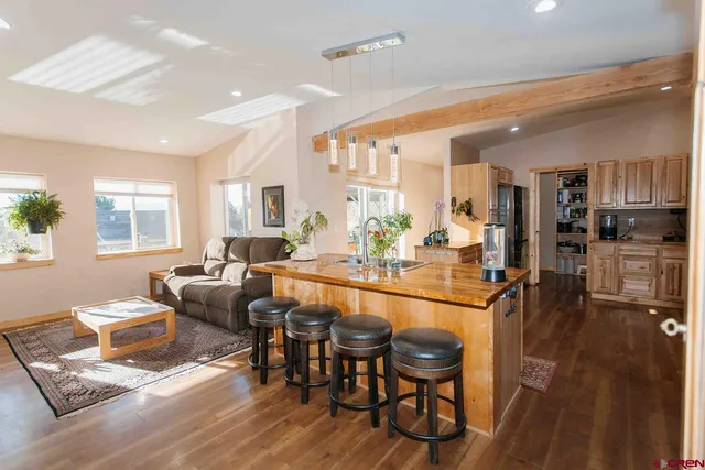 a large kitchen with a table and chairs