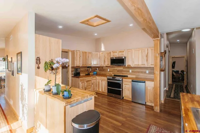 a kitchen with a sink refrigerator and cabinets