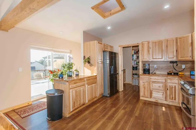 a kitchen with a refrigerator and a stove