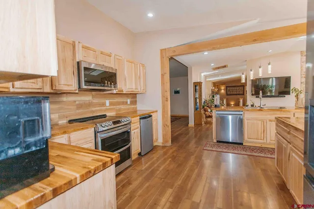 a kitchen with granite countertop a stove top oven and cabinets