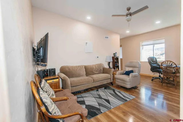 a living room with furniture and wooden floor