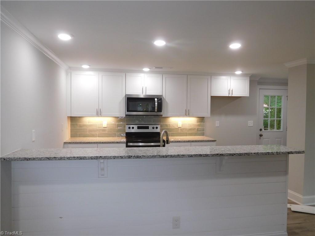1324 Motor Road Winston-Salem, NC 27105 - Photo 8 of 27 Fabulous All New Kitchen! SS Appliances, tile backsplash, granite counters. Tons of workspace and storage.