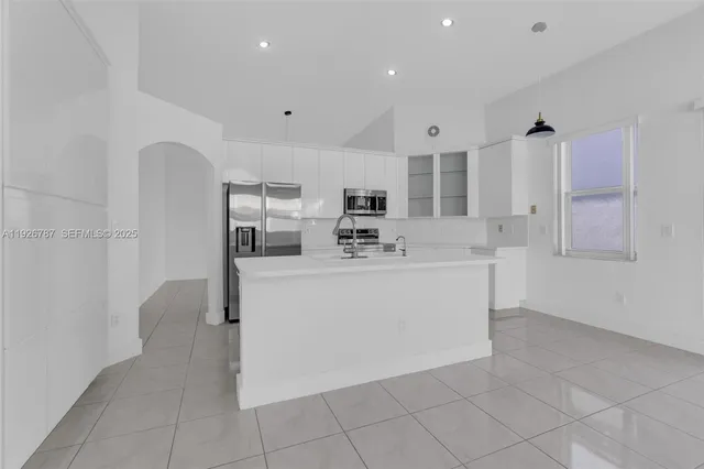 a kitchen with cabinets stainless steel appliances and a counter top space