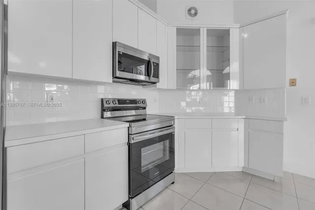 a spacious bathroom with double vanity a mirror a bathtub and shower