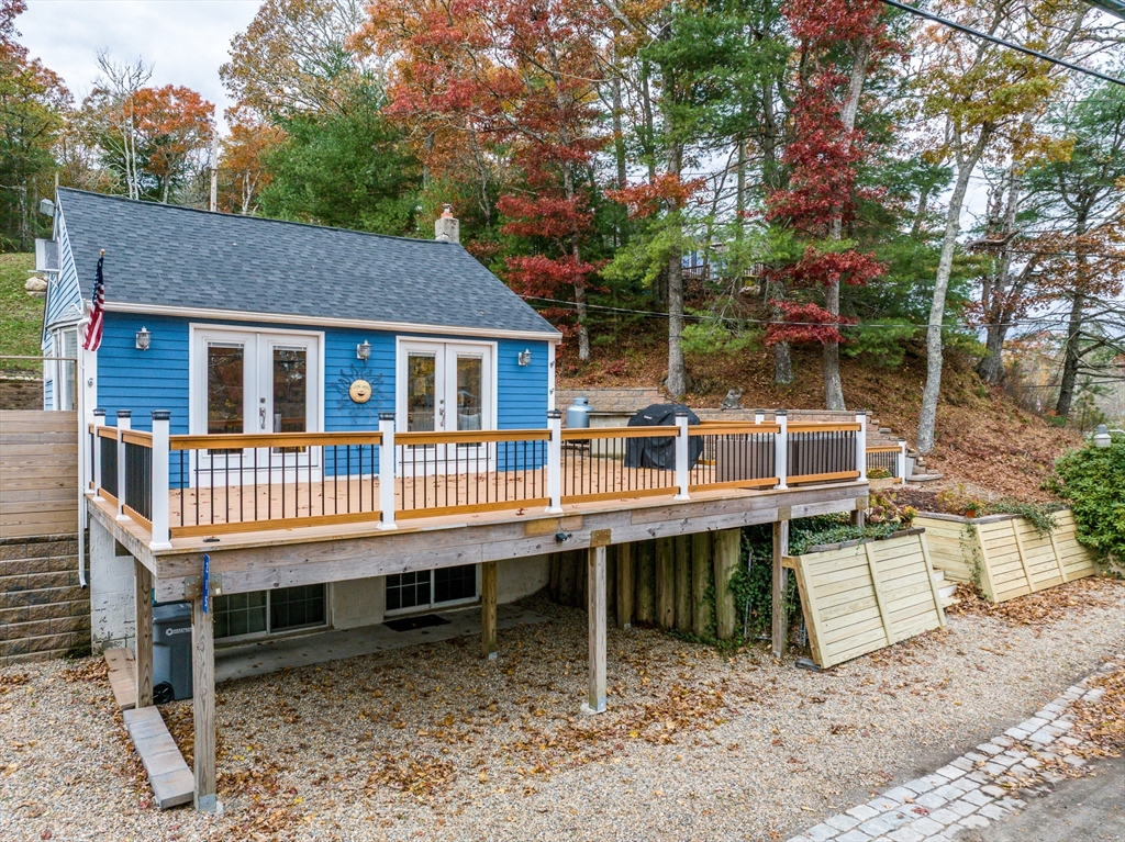 a view of a house with a deck and a yard