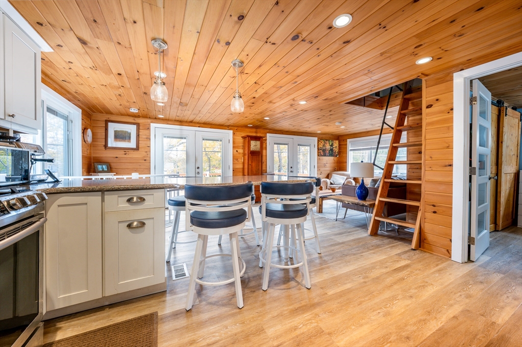 215 Roxy Cahoon Road Plymouth, MA 02360 - Photo 14 of 40 a kitchen with stainless steel appliances kitchen island granite countertop a table and chairs