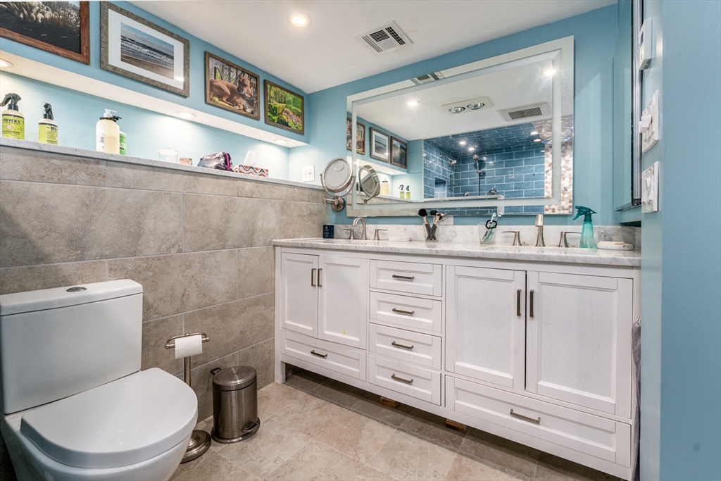 215 Roxy Cahoon Road Plymouth, MA 02360 - Photo 32 of 40 a bathroom with a toilet sink and mirror