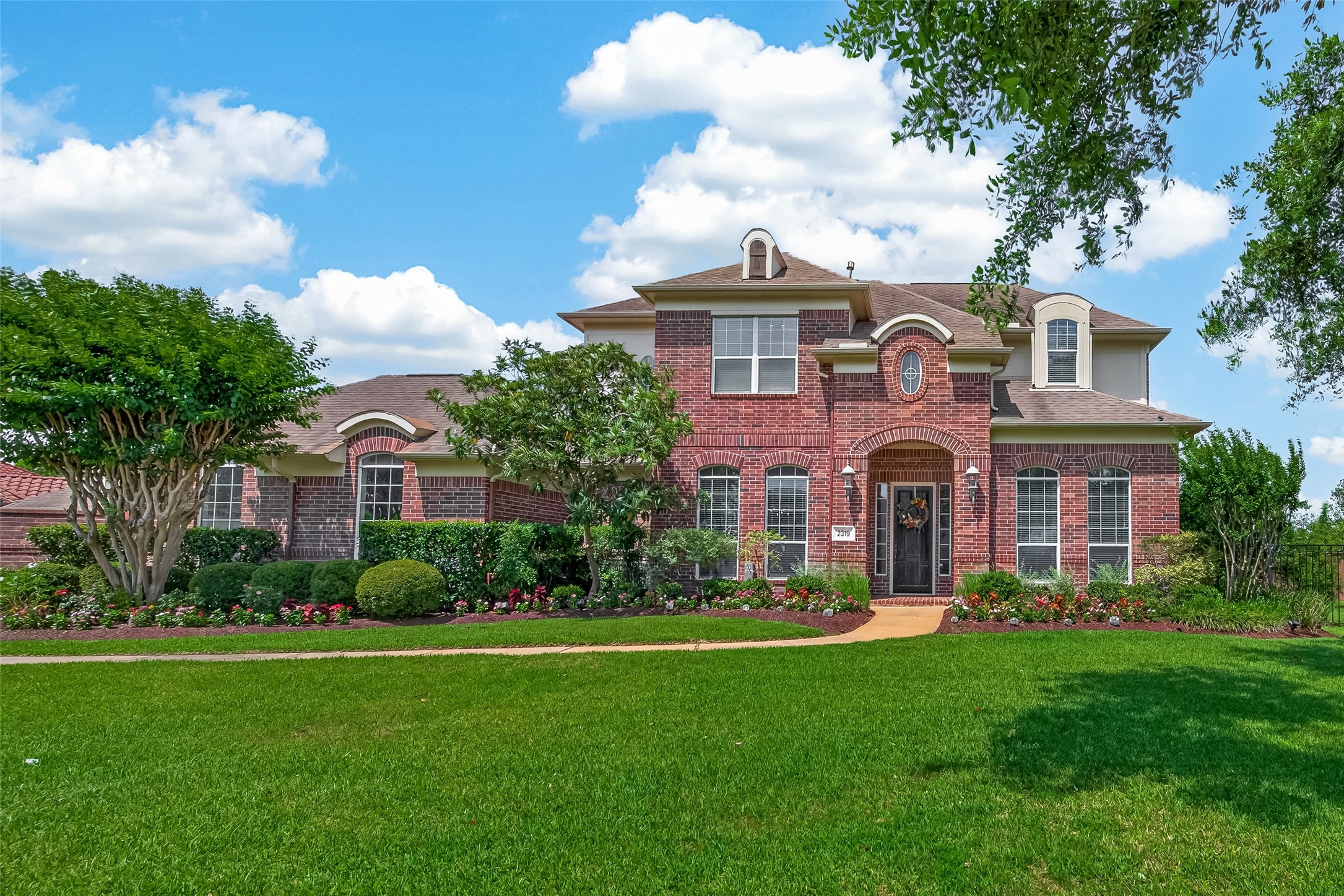 2319 Braer Ridge Drive Katy, TX 77494 - Photo 50 of 50 a front view of a house with a garden and plants