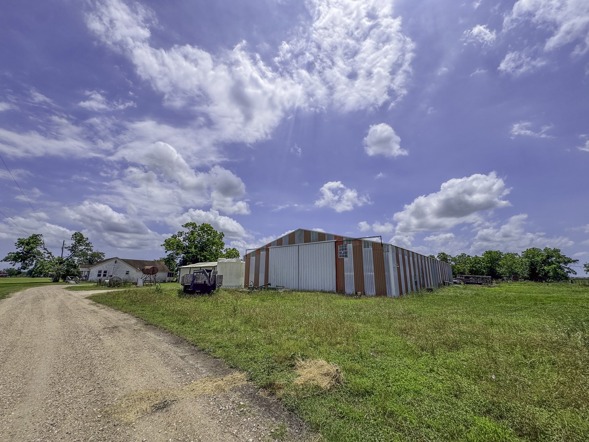 11810 Zamanek Road Needville, TX 77461 - Photo 12 of 30 a view of a house with a big yard and a large tree