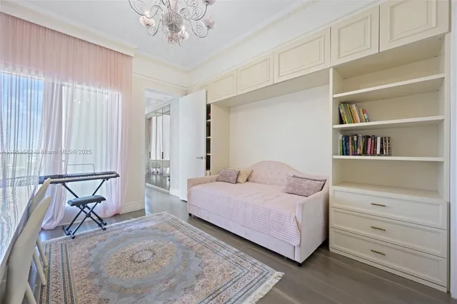 a spacious bedroom with two beds and a chandelier