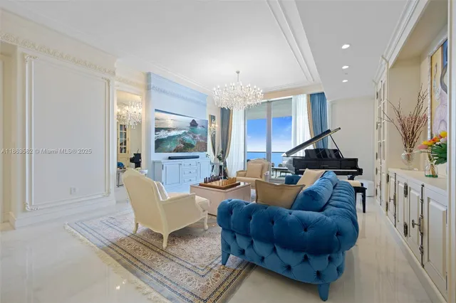 a living room with furniture and a chandelier