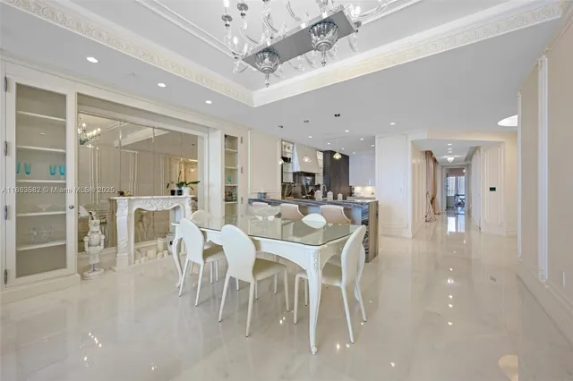 a dining hall with stainless steel appliances a dining table chairs and view living room