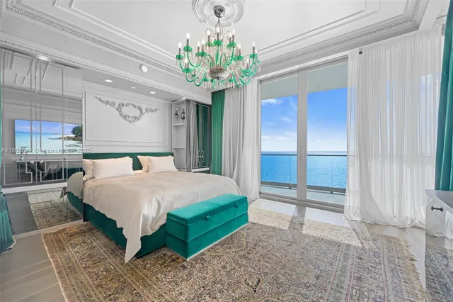 a bedroom with a bed and a chandelier