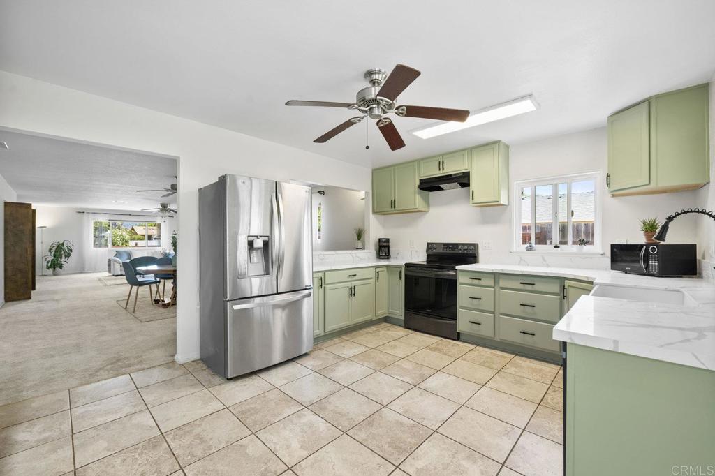 809 Buchanan Street Escondido, CA 92027 - Photo 11 of 32 a kitchen with a sink cabinets and stainless steel appliances
