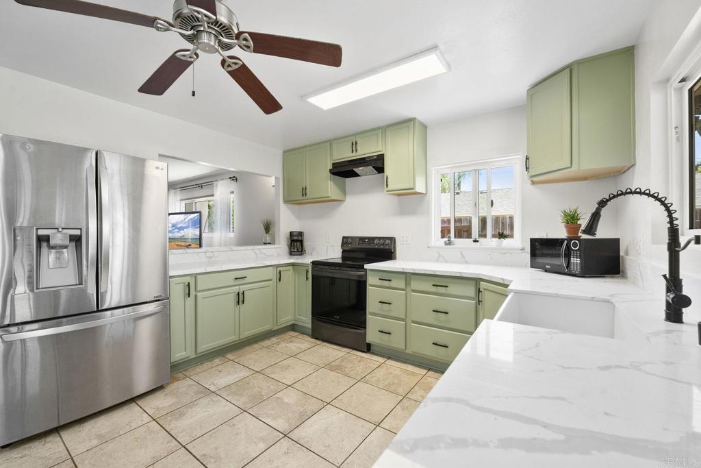 809 Buchanan Street Escondido, CA 92027 - Photo 12 of 32 a kitchen with a refrigerator and a sink