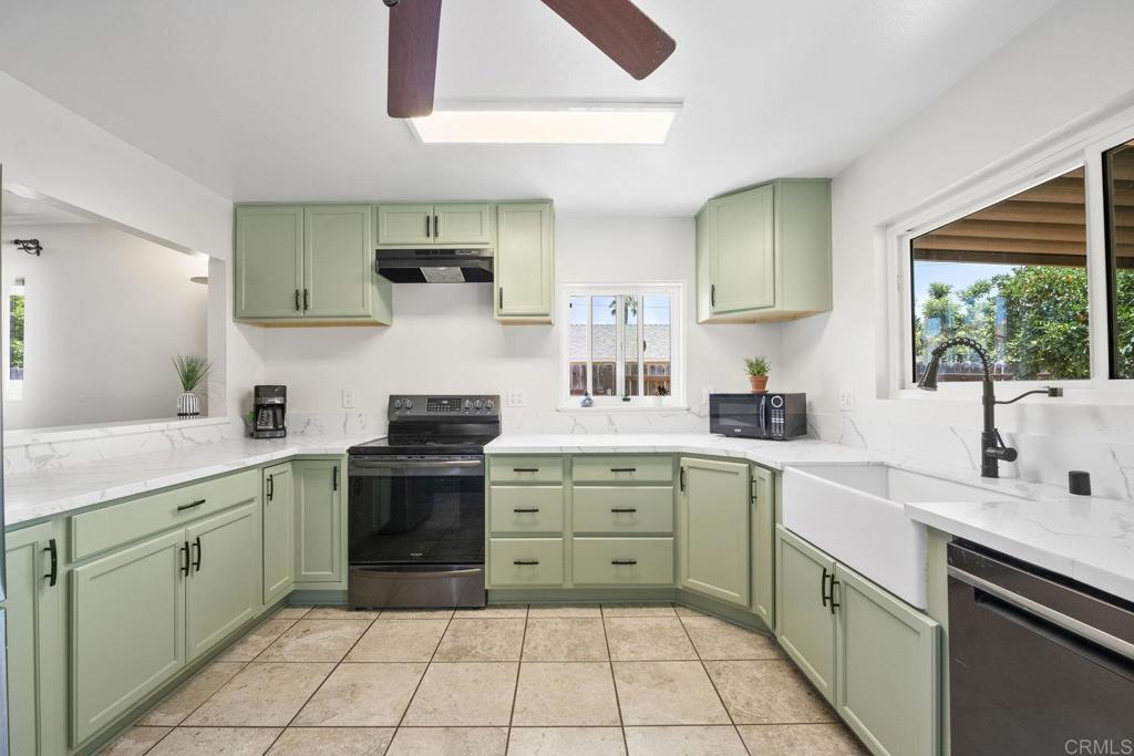 809 Buchanan Street Escondido, CA 92027 - Photo 13 of 32 a kitchen with a stove sink and cabinets