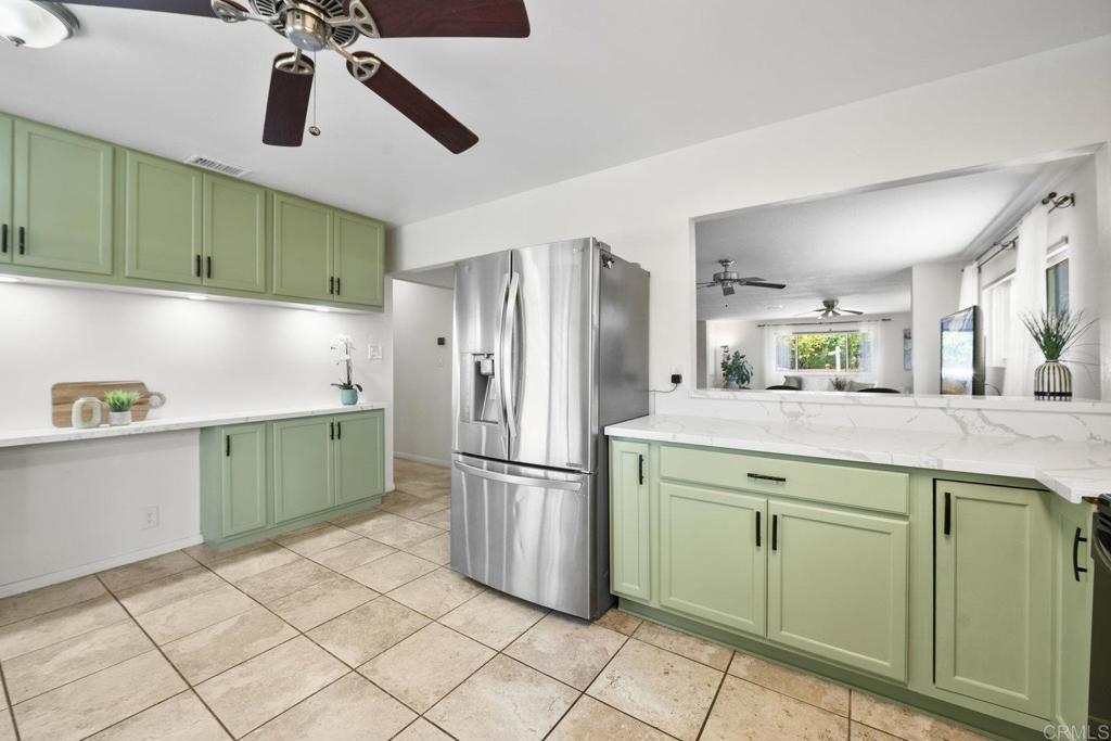 809 Buchanan Street Escondido, CA 92027 - Photo 14 of 32 a kitchen with a refrigerator and cabinets