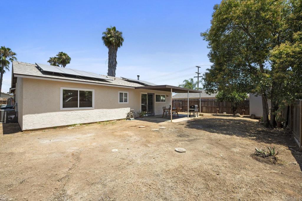 809 Buchanan Street Escondido, CA 92027 - Photo 23 of 32 a view of a house with backyard and a tree