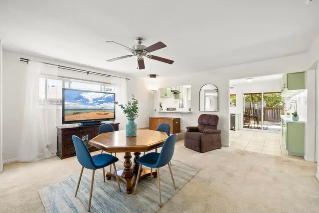 a living room with furniture a large window and a chandelier