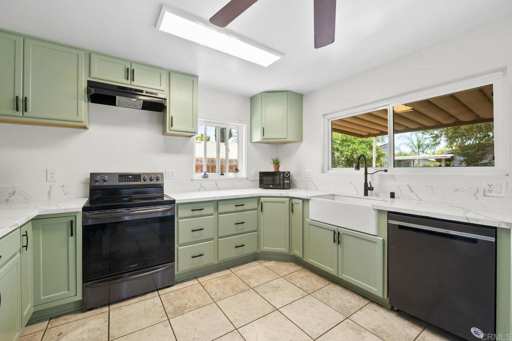 809 Buchanan Street Escondido, CA 92027 - Photo 10 of 32 a kitchen with a sink stove and cabinets