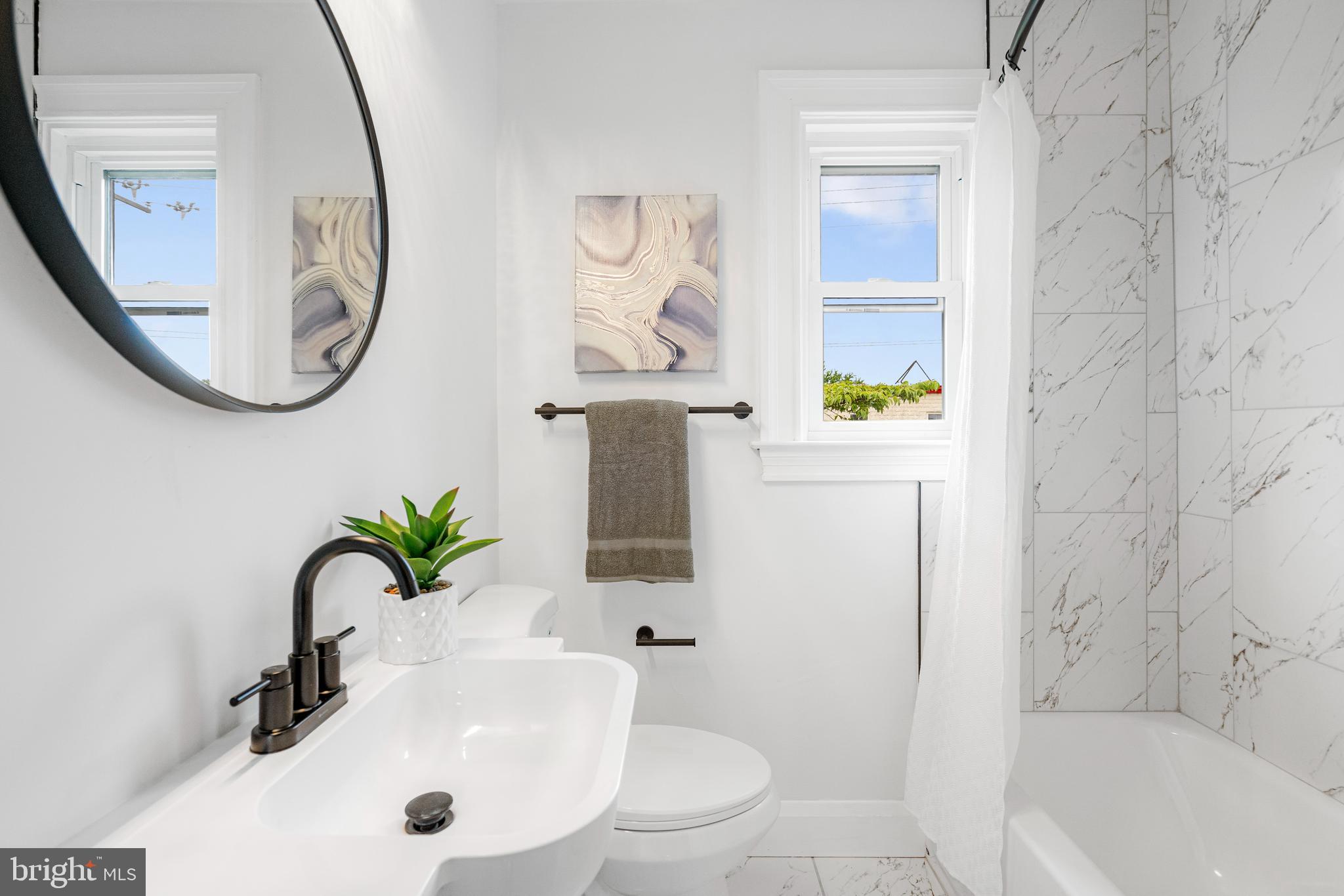 83 Willow Spring Road Dundalk, MD 21222 - Photo 24 of 36 a bathroom with a sink a toilet and a mirror