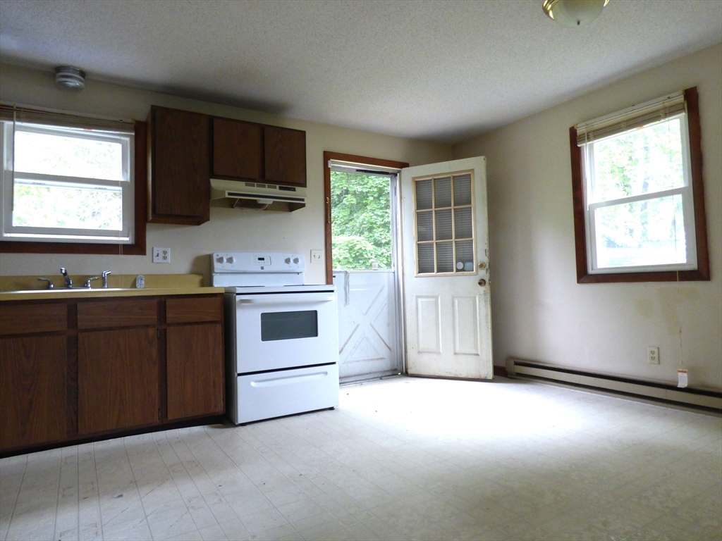 16-18 Daniel Street Springfield, MA 01151 - Photo 5 of 14 a kitchen with stainless steel appliances a stove sink and microwave