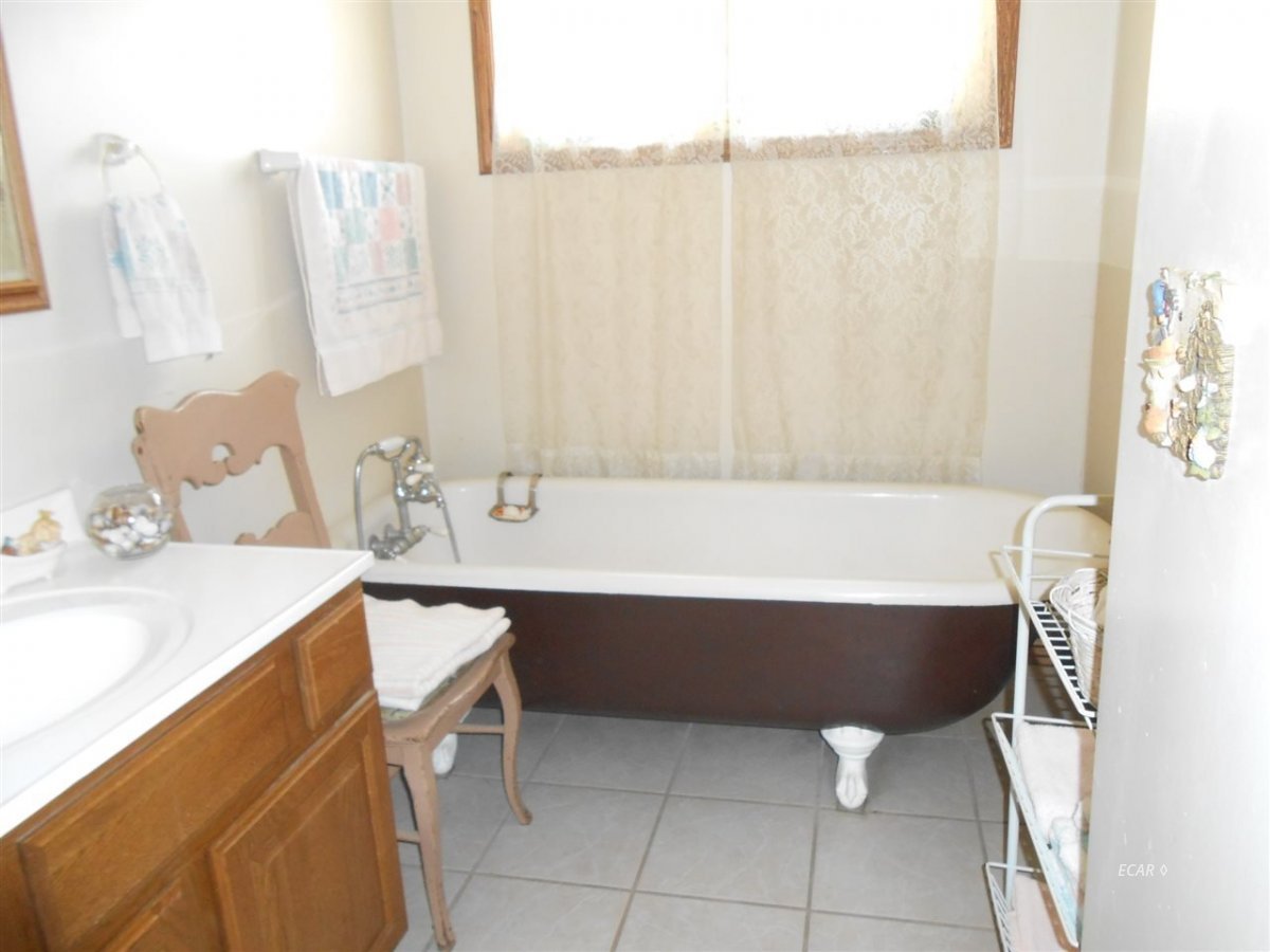 9039 Ruby Valley Road Spring Creek, NV 89815 - Photo 41 of 47 a bathroom with a sink vanity and tub