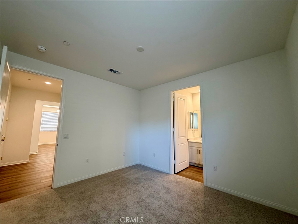 21624 Thomas Court Riverside, CA 92507 - Photo 30 of 36 an empty room with wooden floor and windows