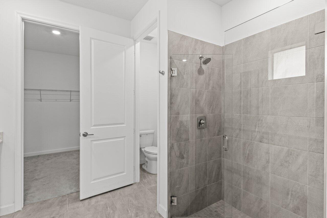 19659 Rugged Trunk Trail Loxahatchee, FL 33470 - Photo 18 of 61 a bathroom with a shower and a sink