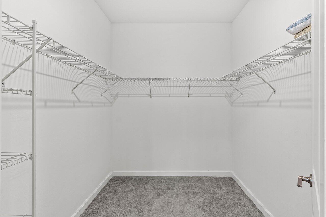 19659 Rugged Trunk Trail Loxahatchee, FL 33470 - Photo 19 of 61 a view of a room with racks on the wall