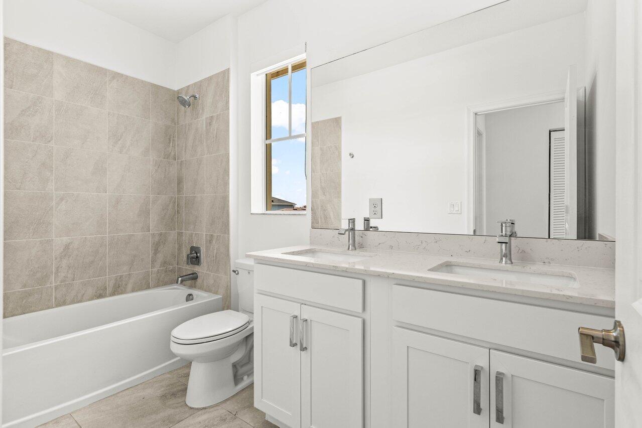 19659 Rugged Trunk Trail Loxahatchee, FL 33470 - Photo 26 of 61 a bathroom with a sink a toilet and shower