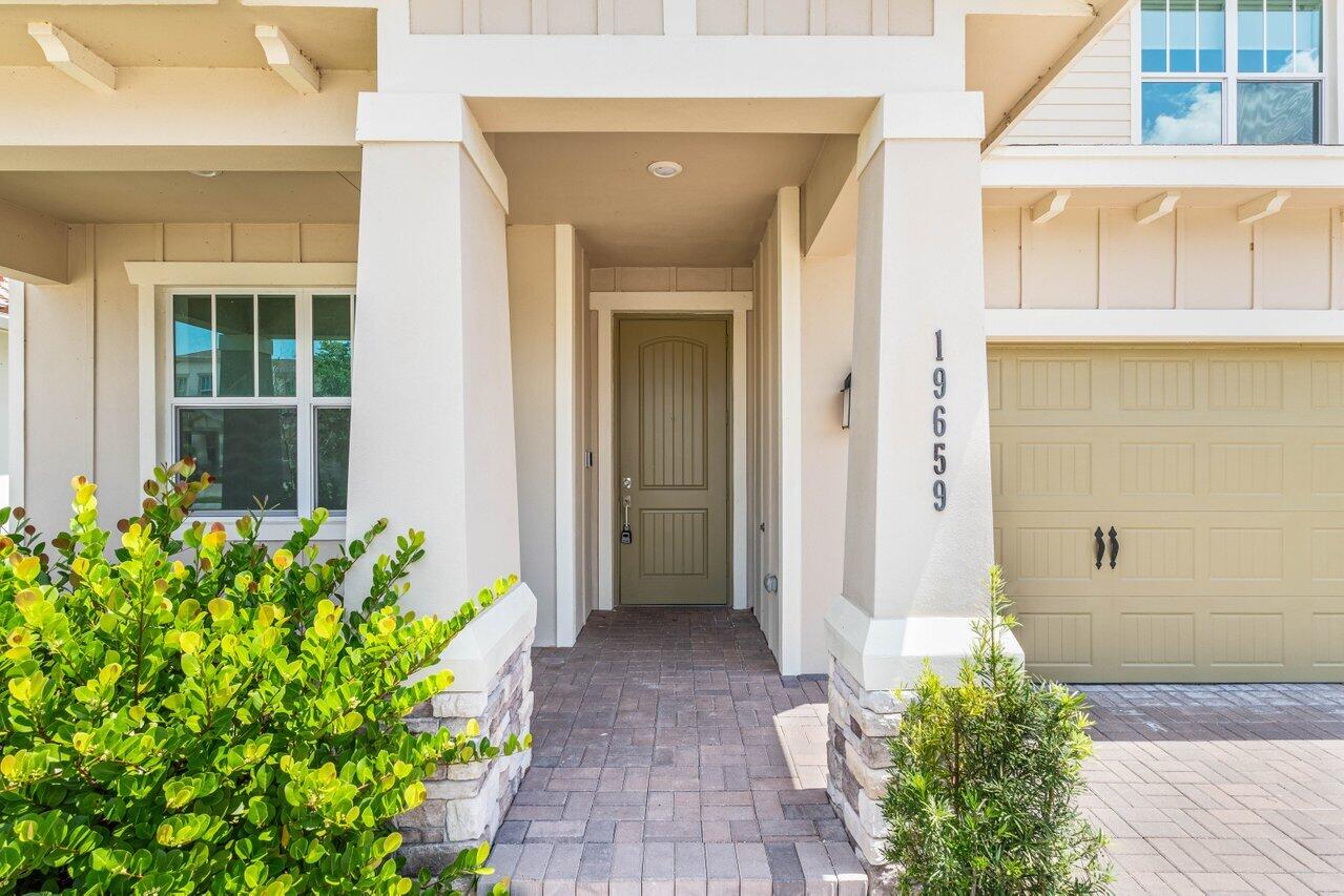 19659 Rugged Trunk Trail Loxahatchee, FL 33470 - Photo 3 of 61 a front view of a house with an outdoor space