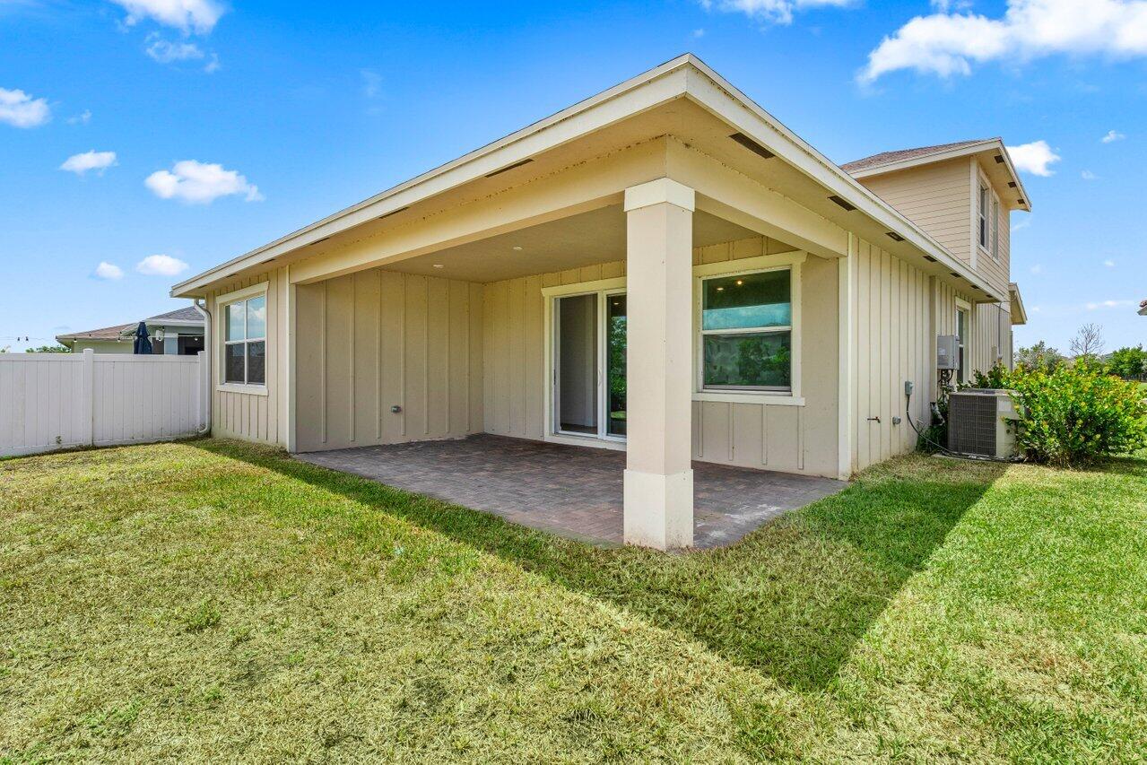 19659 Rugged Trunk Trail Loxahatchee, FL 33470 - Photo 32 of 61 a view of a house with backyard and garage