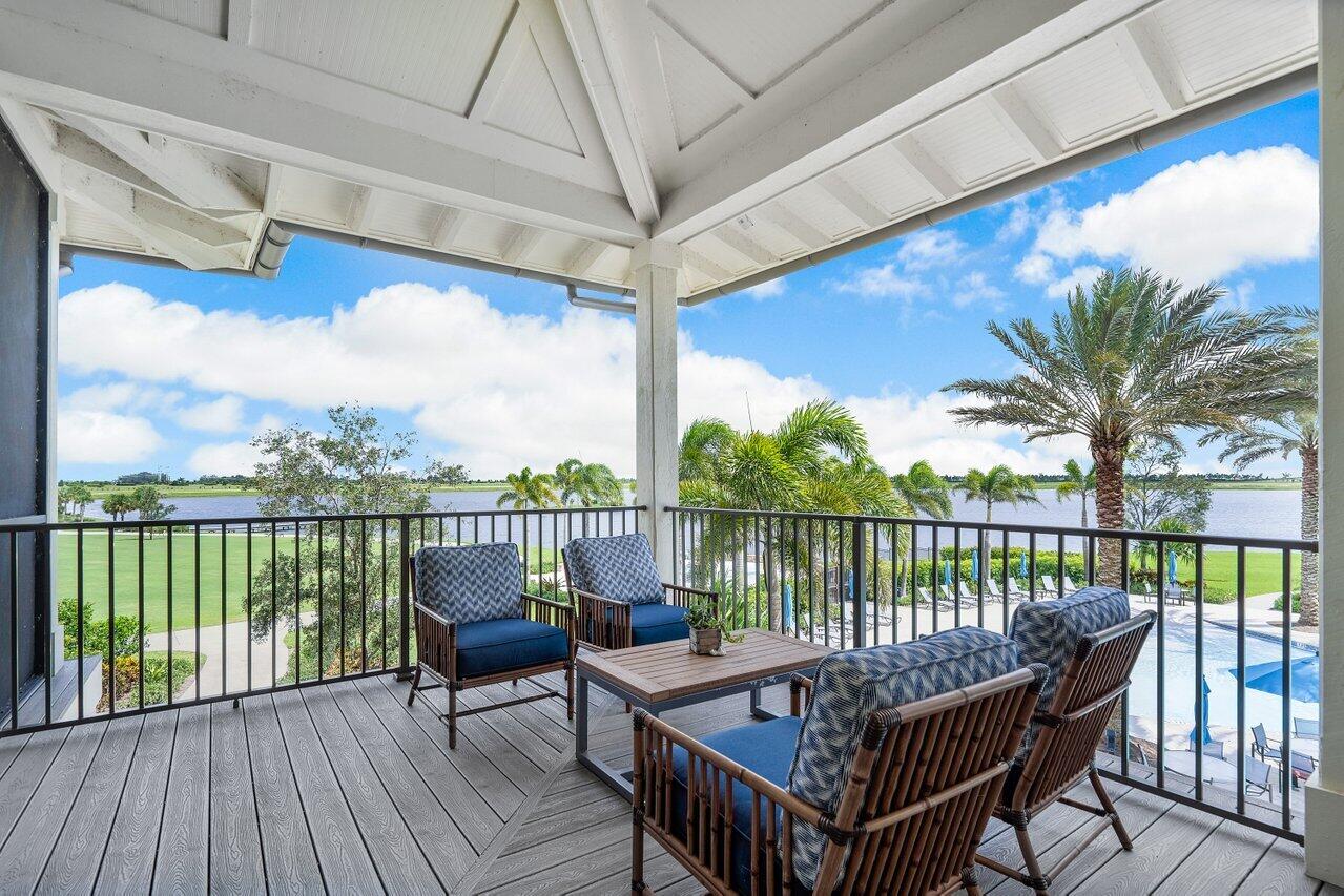 19659 Rugged Trunk Trail Loxahatchee, FL 33470 - Photo 50 of 61 a view of a balcony with wooden floor and outdoor seating