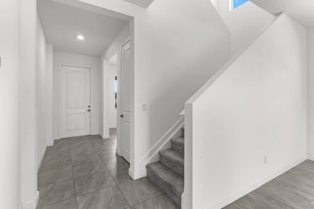 a living room with furniture a flat screen tv and a lamp